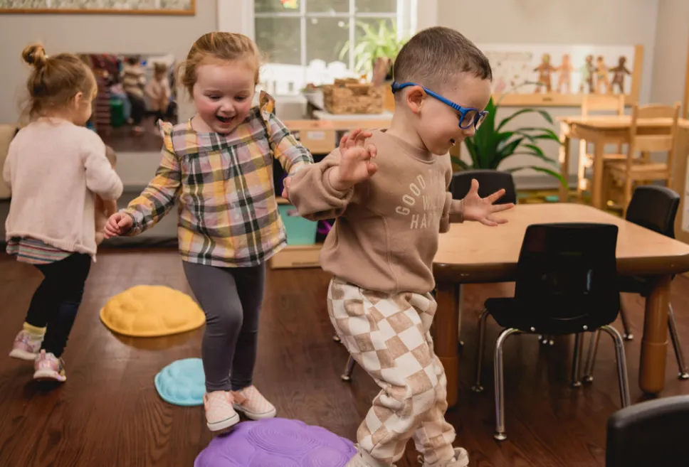 Preschoolers Hopping on colorful stepping stones