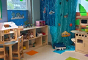 Wooden kitchen playset with ocean themed wall art 