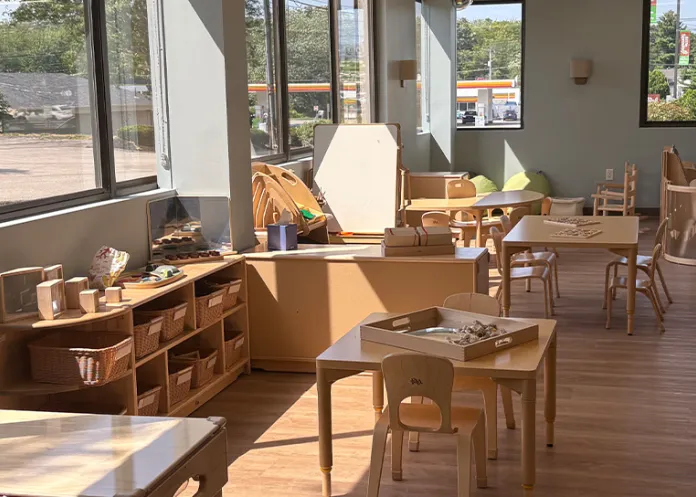 Sunny Preschool Classroom at Little Sprouts Marlborough, MA with wooden storage cubbies and bins 