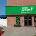 Front entrance of Little Sprouts Early Education and Child Care in Merrimack, New Hampshire, featuring welcoming signage and landscaped entryway.
