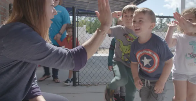 Teacher giving students a high five