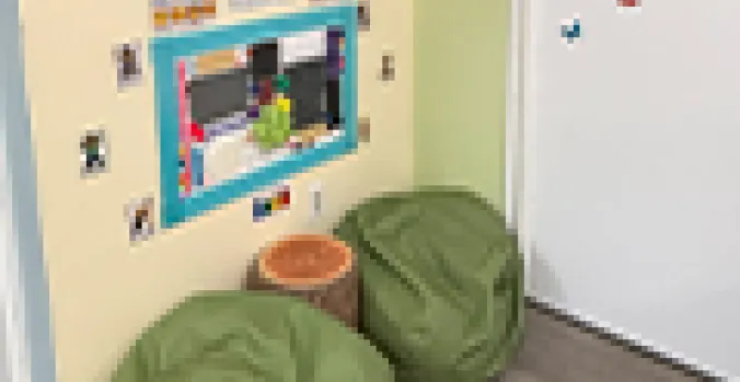 Two green beanbag chairs in a cozy corner