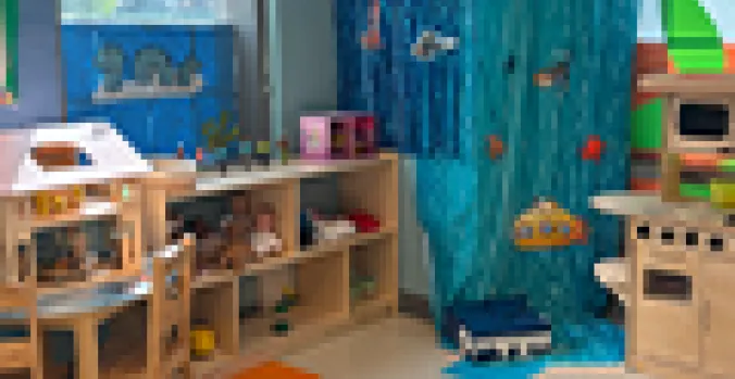 Wooden kitchen playset with ocean themed wall art 