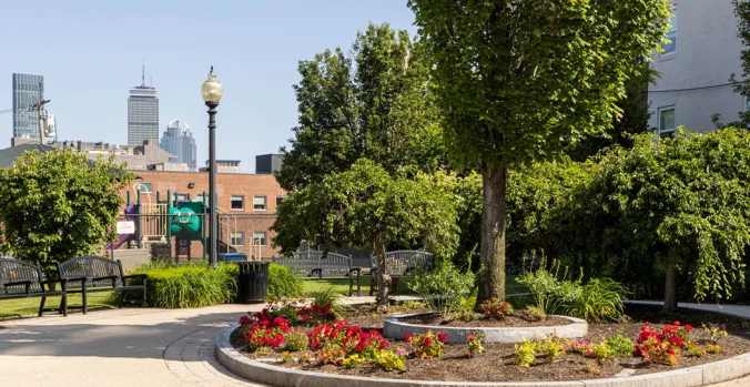 The Park at Little Sprouts BUMC featuring a circular garden with trees and park benches